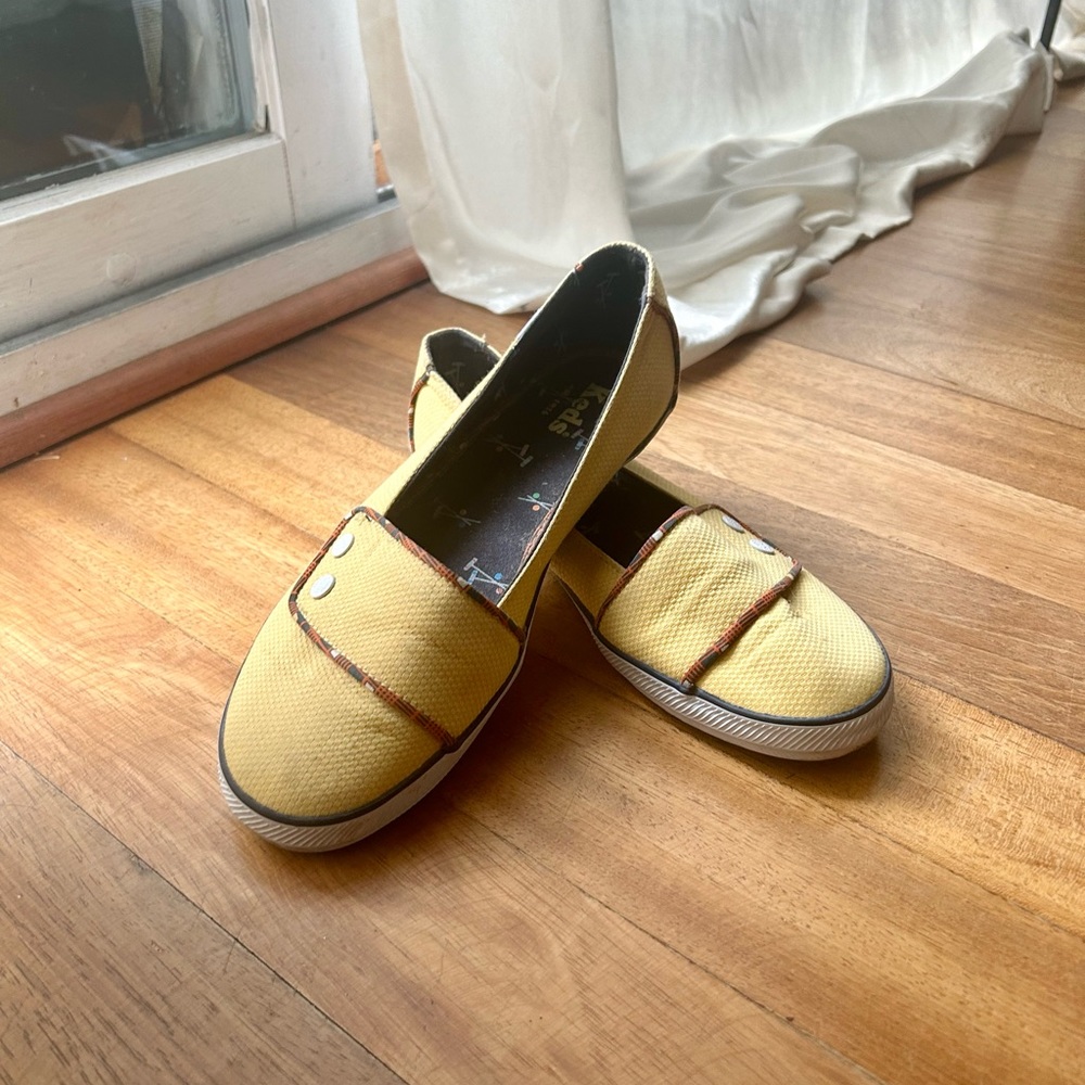 Yellow Keds slip-on shoes with buttons
